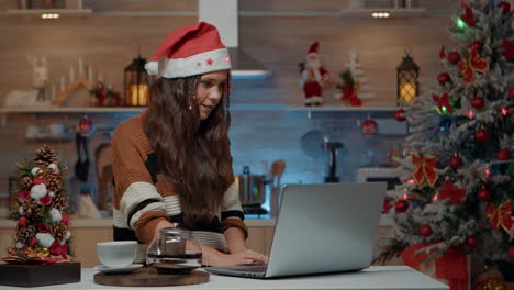 festive woman holding credit card to shop online
