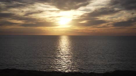 golden sunset over the sea with a cloudy sky