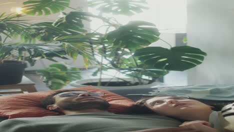 loving couple lying on sofa and chatting