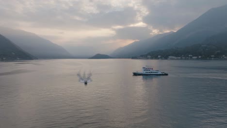 4k-Aéreo---Descenso-Lento-Al-Atardecer-Mientras-La-Lancha-Rápida-Se-Acerca-A-La-Cámara-En-El-Lago-De-Como,-Italia