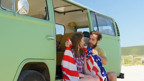 young man wrapping beautiful woman with the american flag 4k