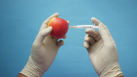 Doctors-hand-holding-green-apple-while-sited-,