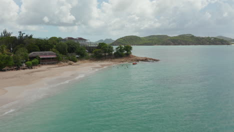 Aerial-low-angle-establishing-shot-of-caribbean-coast-in-Antigua-and-Bermuda