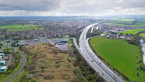 Aerial-drone-cinematic-video-footage-of-the-M1-Motorway-near-the-city-of-Wakefield,-West-Yorkshire,-UK
