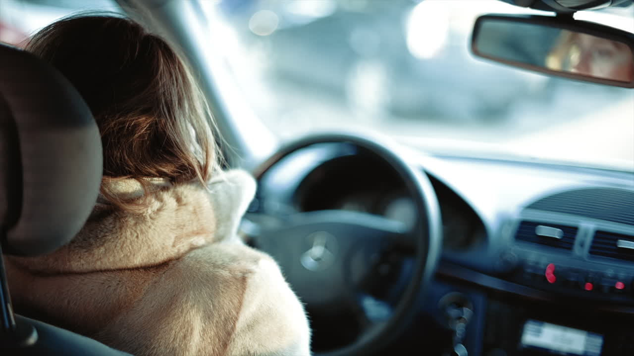 Woman driving a car in slow motion, hands on wheel