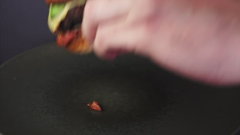 man taking and biting an american cheeseburger