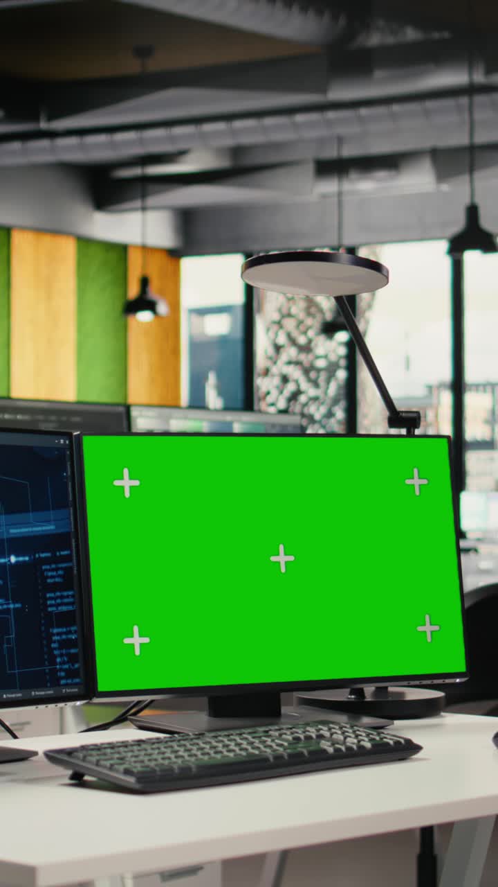 Vertical video Green screen PCs on office desk used to implement machine learning