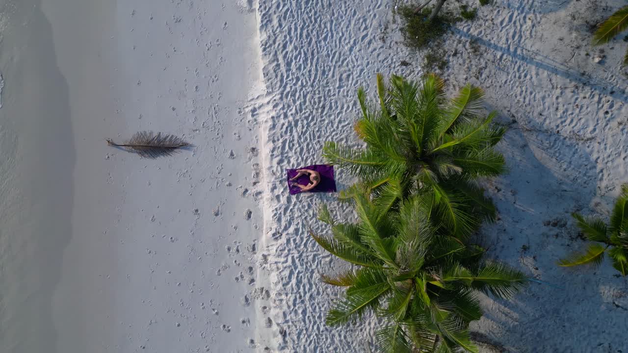 Santa claus is enjoying summer holidays on a beautiful tropical beach. Fantastic aerial view flight ascending drone