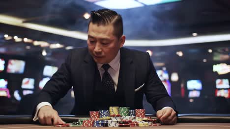 intense focus: a professional player strategically organizes his chips in a high-stakes casino environment, showcasing skill and determination amidst the exciting ambiance.