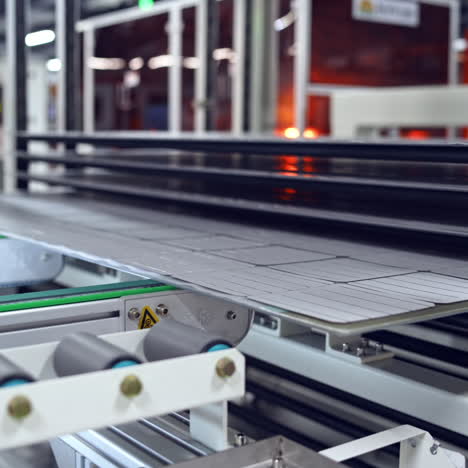 automated factory equipment of energy device at work. special machine makes new solar panels.