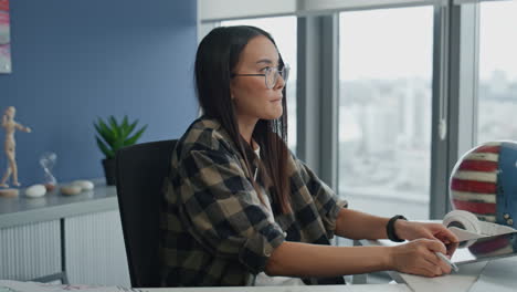 Focused-programmer-working-tablet-office-closeup.-Thoughtful-woman-watching-pad