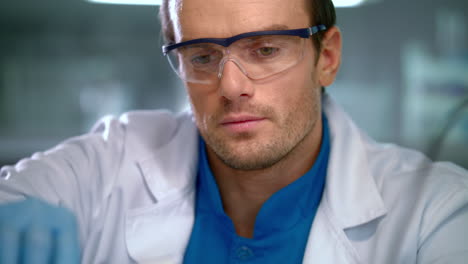 scientist face. portrait of researcher working in safety glasses