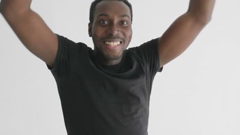 man celebrating with raised arms