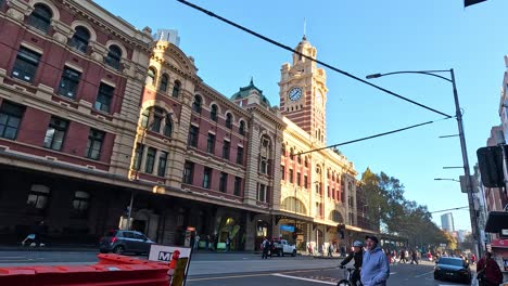 people and traffic near historic building in melbourne