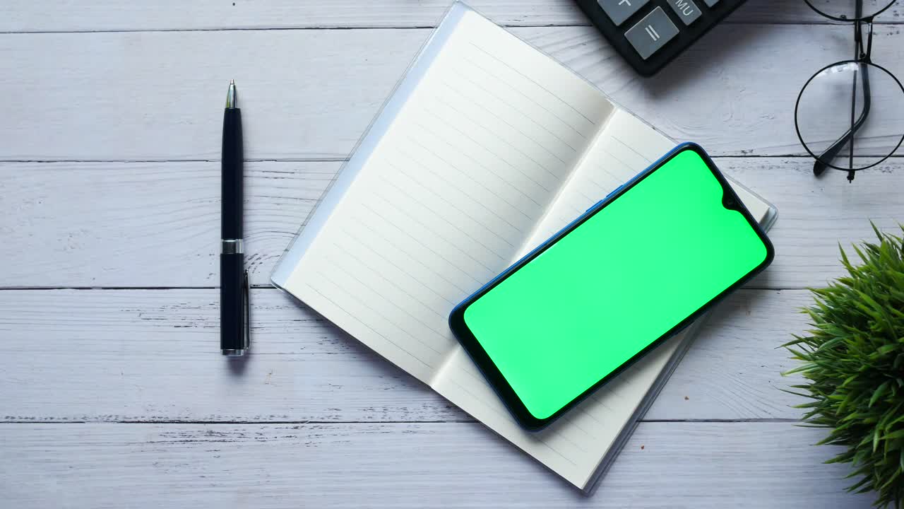 Office Workspace with Smartphone and Notebook