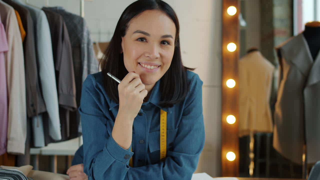 Confident Fashion Designer in Her Workshop