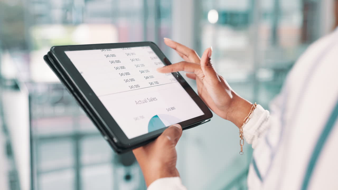 Businesswoman reviewing financial data on tablet