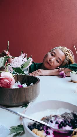 woman enjoying a peaceful breakfast with flowers