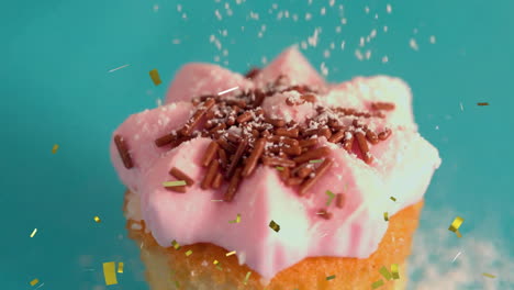 cupcake with pink frosting and sprinkles, confetti animation falling  around it