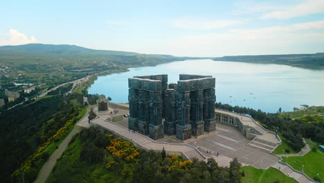 aerial view of the chronicle of georgia monument overlooking a lake near tbilisi
