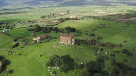 old church in the middle of green field - aerial drone shot