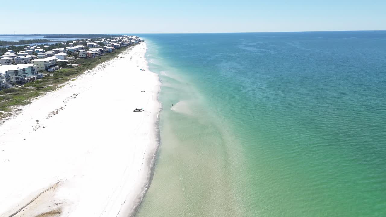 Drone orbit near the coastal houses at sandy shoreline in summer, Cape San Blas, Gulf County, Florida, USA