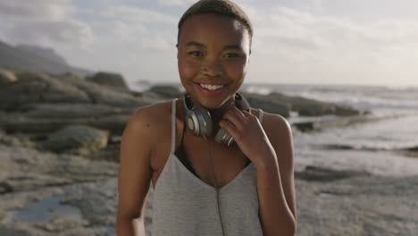 close up of young woman laughing cheerful wearing headphones at beach sunny seaside