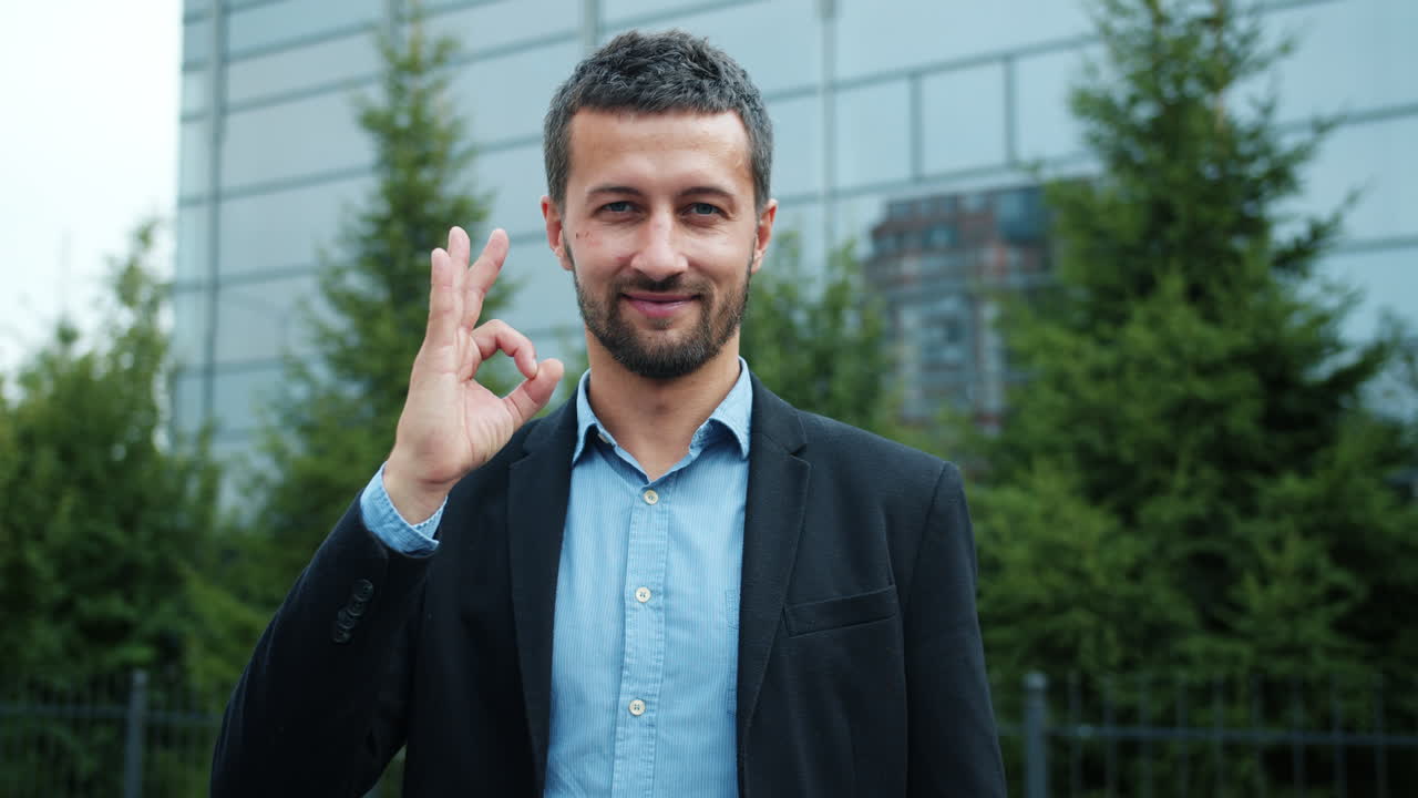 Man in business suit giving ok sign
