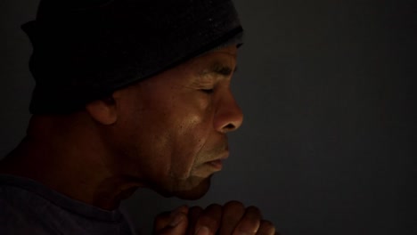 man-praying-to-god-with-hands-together-on-grey-background-stock-video