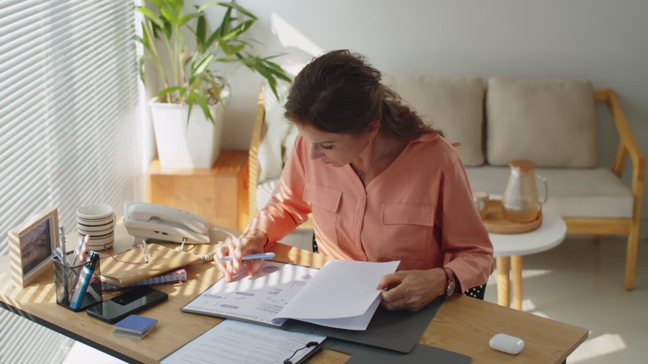 Serious Businesswoman Editing Financial Report