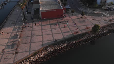 working class people getting their workout done together on the riverbank, drone