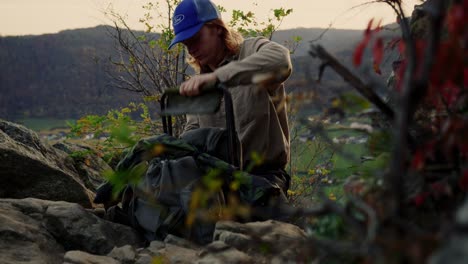 experienced hiker packing his chair in backpack to continue his trip, dürnstein