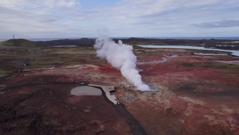 smoke in the form of sulfur vapor rising from the gunnhuver, iceland