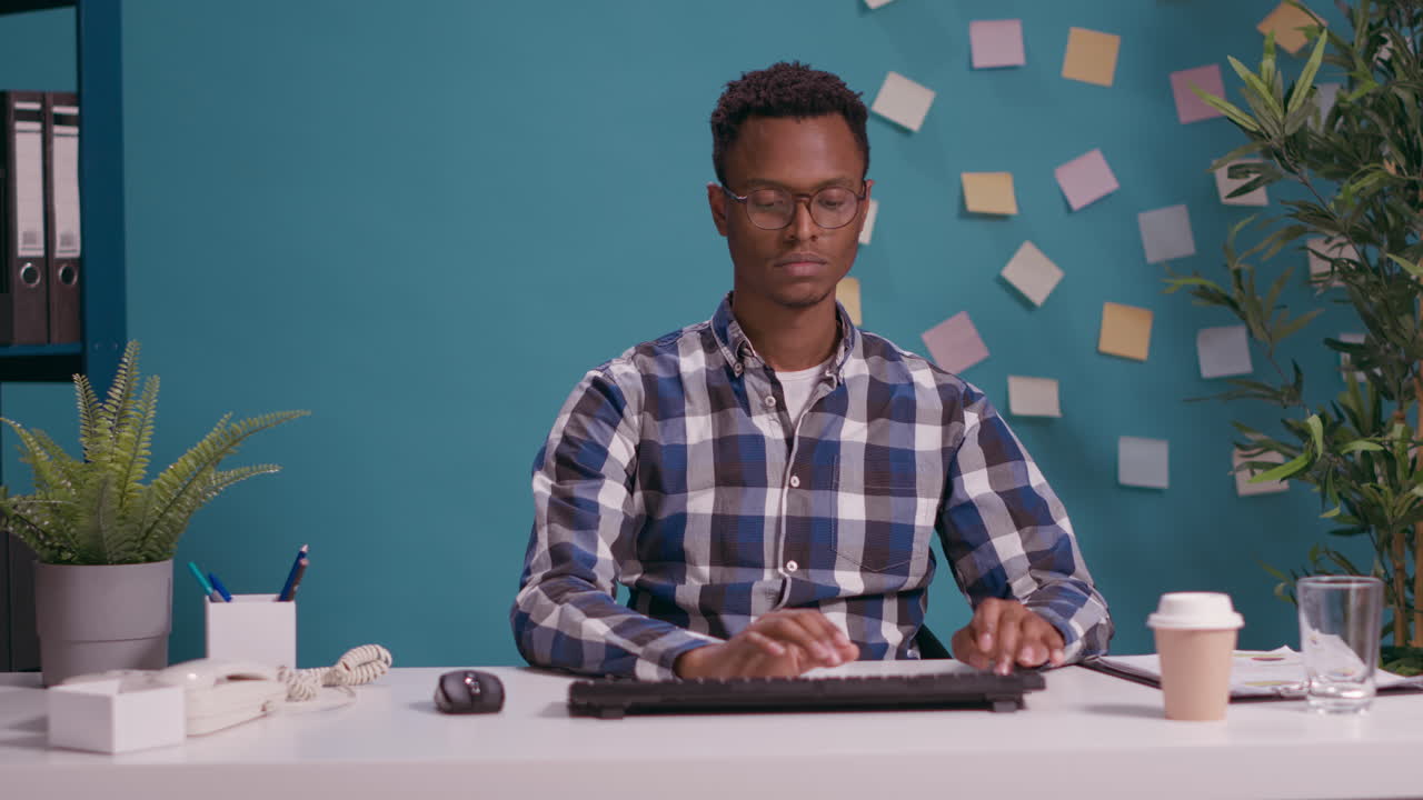 Portrait of african american man using computer at desk