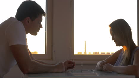 family couple playing with magnet puzzle at home