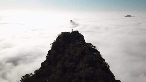 glasshouse mountain early morning drone views of hiker walking above the clouds queensland