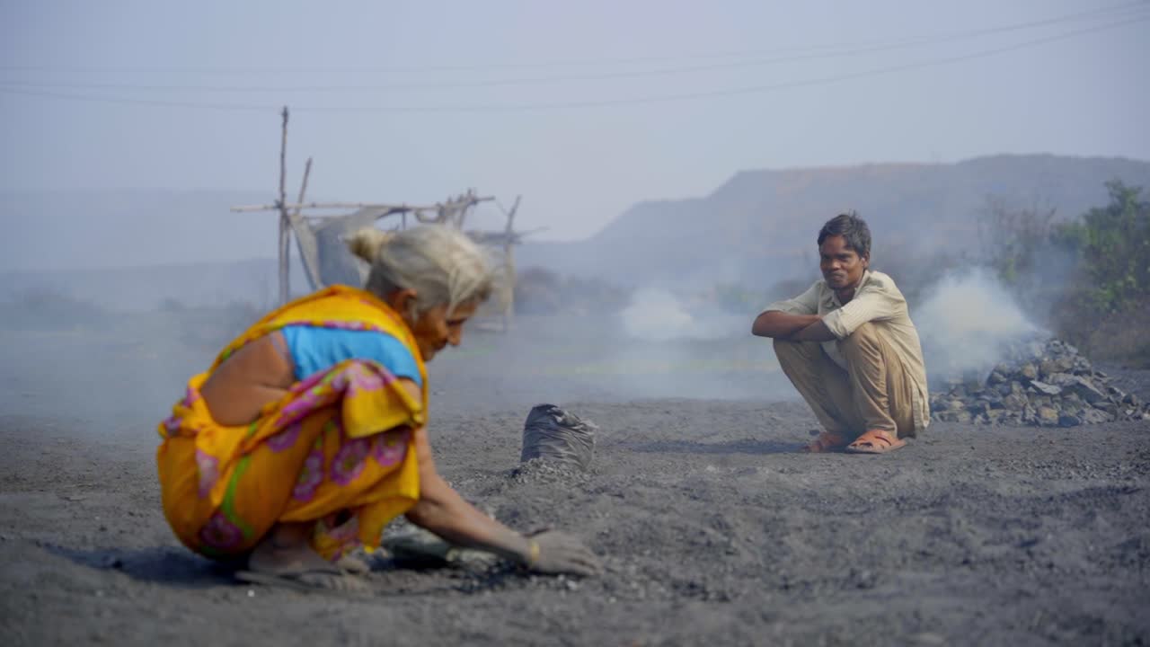 Manual Laborers Working in a Dusty, Industrial Environment