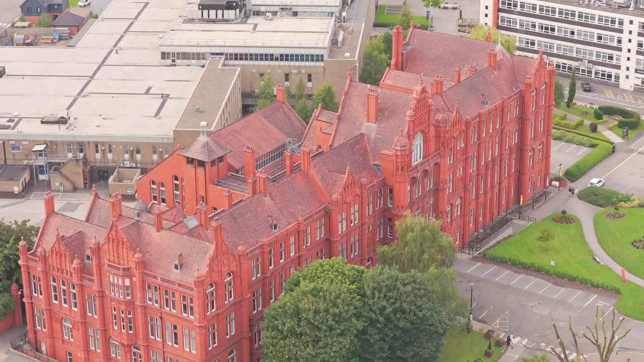 Salford University buildings and campus viewed from above showing red brick architecture and surrounding buildings and green space in Greater Manchester, England