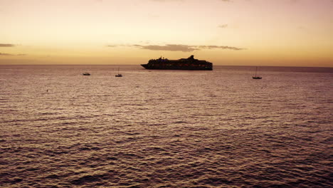 Crucero-De-Lujo-Navegando-Hacia-El-Horizonte-Del-Océano-Al-Atardecer-4k-Drone-Con-Silueta