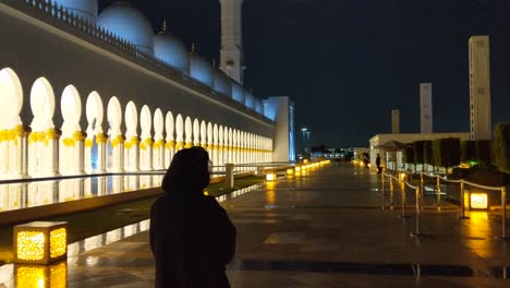 outside the largest mosque of uae.because of covid-19 an exceptional empty evening scenery of the sheikh zayed mosque in abu dhabi. a handful of tourists in the seventh biggest mosque of the world.
