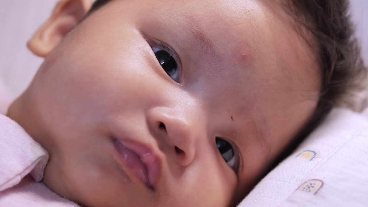 A tender moment showcasing the loving care given to a baby girl during her daily routine.