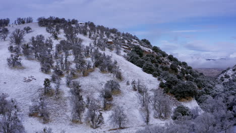 ascending aerial view of the tehachapi mountains covered in a fresh layer of snow