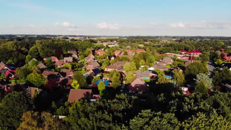 a drone aerial flight towards a villige slowly pointing the camera down