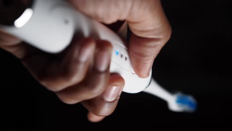 person holding an electric toothbrush