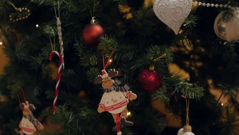 Hanging-a-reindeer-decoration-on-a-Christmas-tree