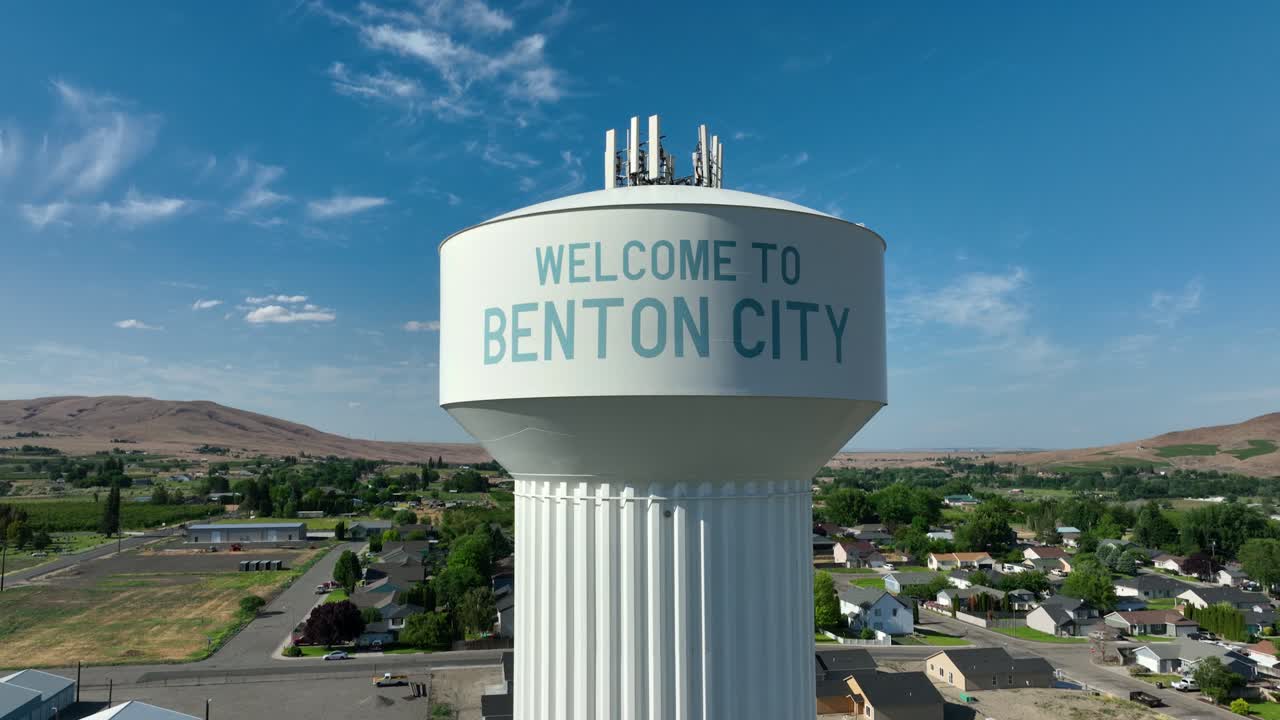 Tight drone shot rising up, featuring Benton City's water tower