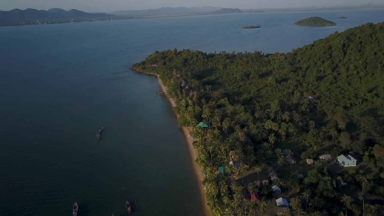 Aerial view of a tropical island with a beach, sea, and vegetation