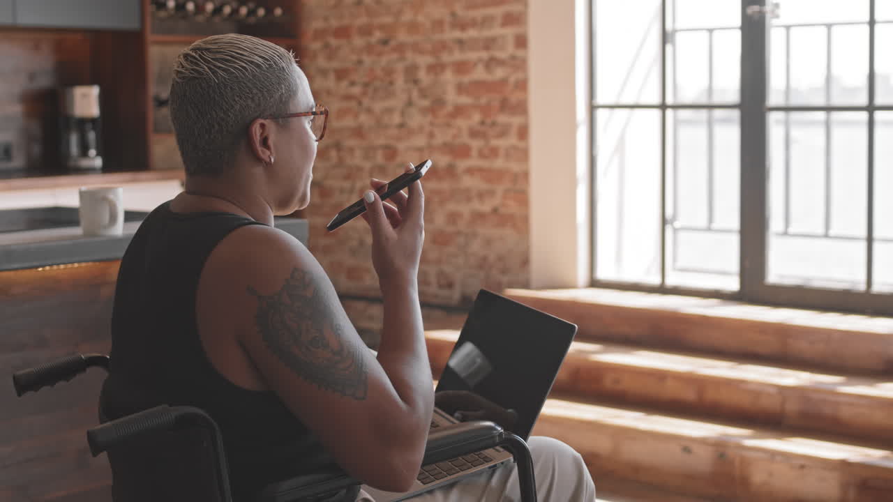 Woman in Wheelchair Talking on Speakerphone