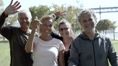 group of happy mature men and women standing together