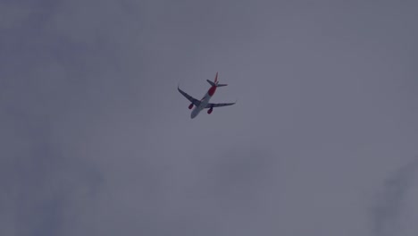 Tracking-shot-of-flying-boeing-airplane-through-clouds-during-beautiful-summer-day